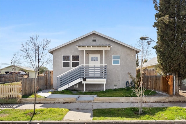 bungalow-style house featuring crawl space, stucco siding, and fence
