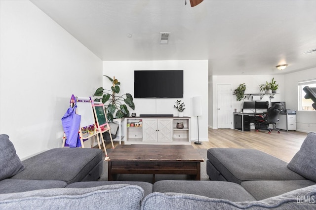 living room with wood finished floors and visible vents