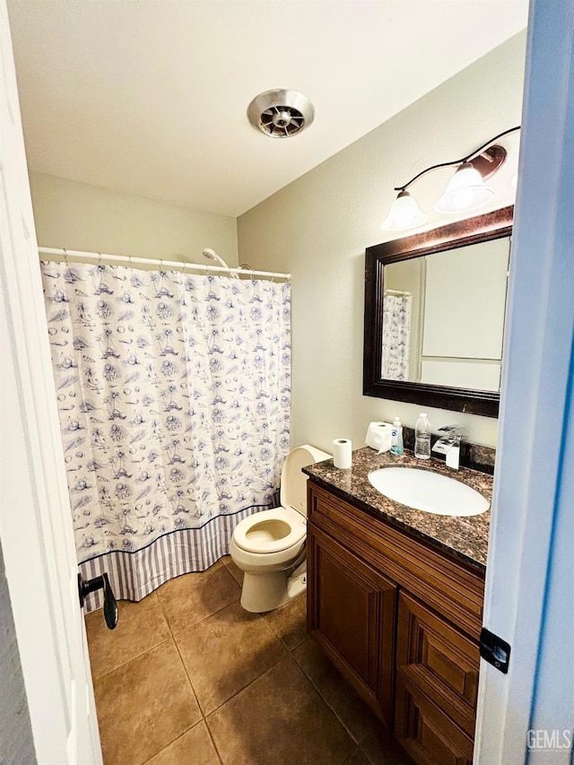 full bathroom with tile patterned floors, curtained shower, toilet, and vanity