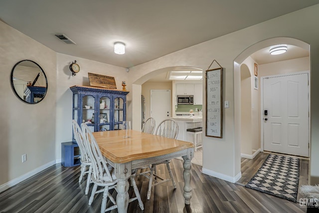 dining area with dark hardwood / wood-style floors