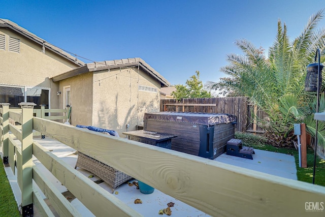 exterior space featuring a jacuzzi