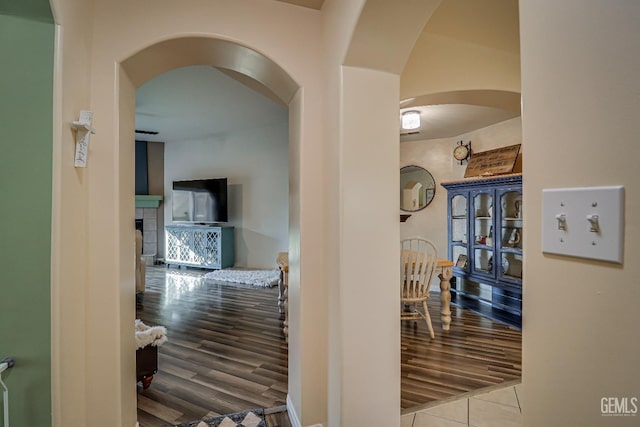 hall with tile patterned floors