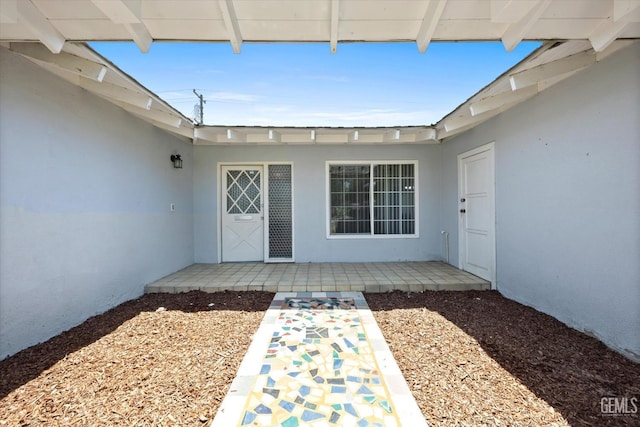 doorway to property with a patio