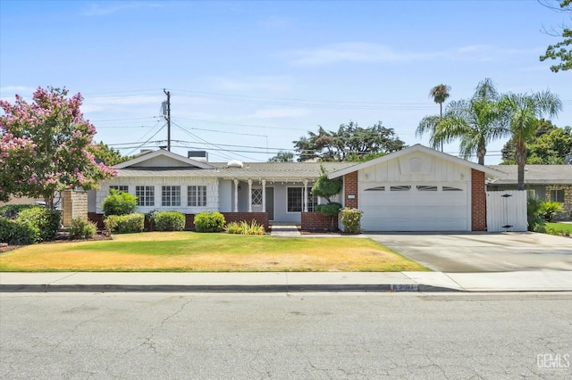 single story home with a front yard and a garage