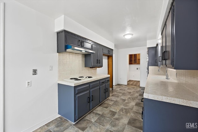 kitchen featuring white electric cooktop, decorative backsplash, and sink