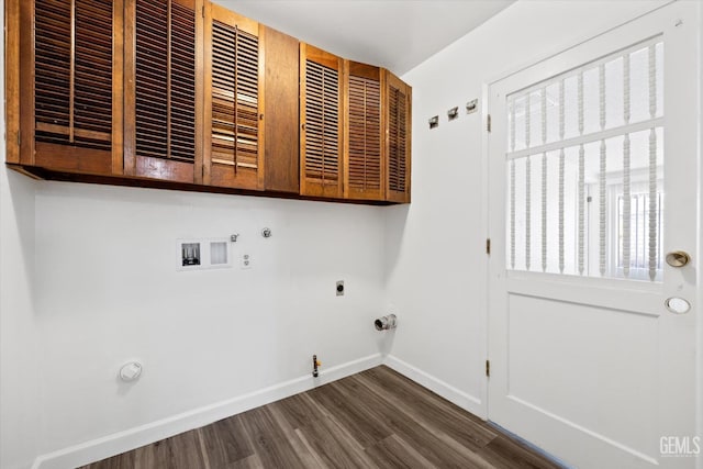 washroom featuring dark wood-type flooring, gas dryer hookup, hookup for a washing machine, and cabinets