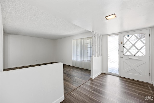 entryway featuring a textured ceiling and dark hardwood / wood-style floors