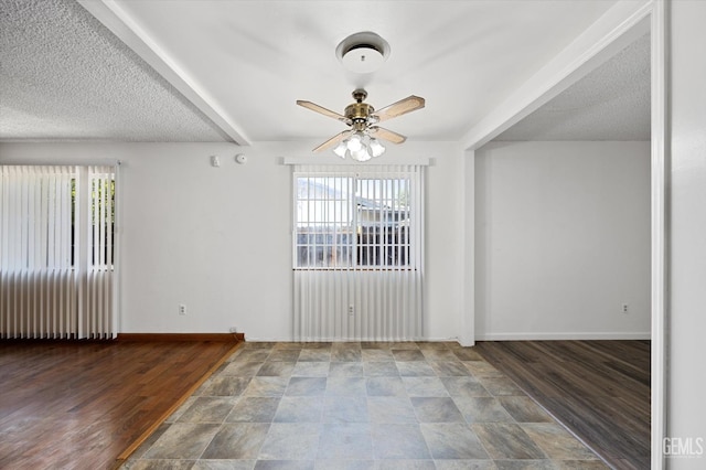 empty room featuring a textured ceiling, plenty of natural light, and ceiling fan