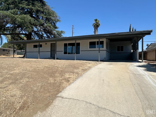 3417 River Blvd, Bakersfield, CA 93305 - ranch-style house featuring concrete driveway, stucco siding, and a carport