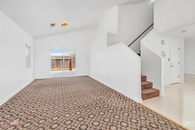 stairs with lofted ceiling, baseboards, visible vents, and carpet floors