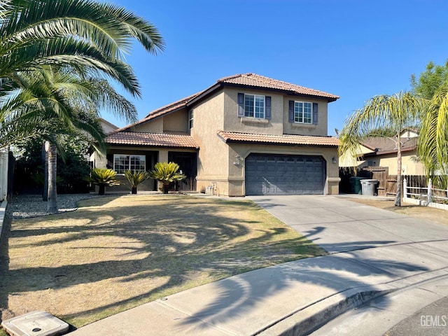 mediterranean / spanish-style home with stucco siding, a tile roof, fence, concrete driveway, and a garage