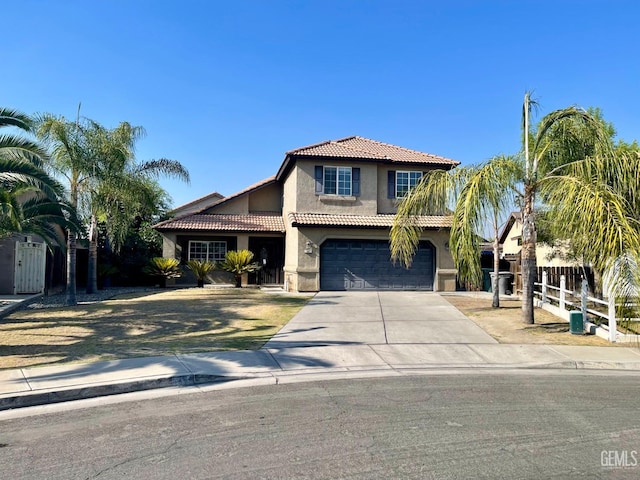 view of front facade with fence, a tiled roof, concrete driveway, stucco siding, and an attached garage