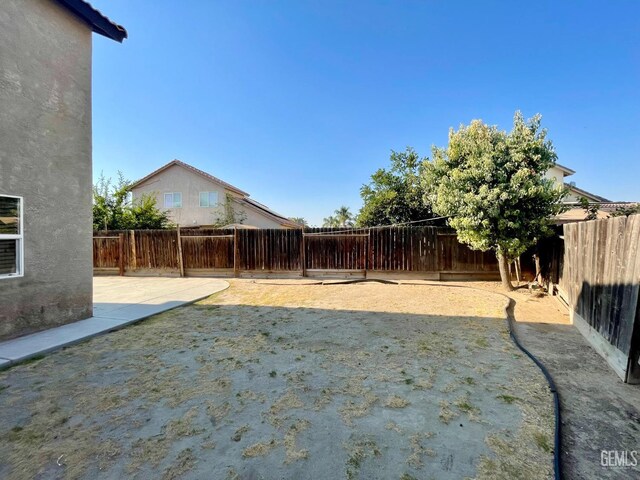 view of yard featuring a patio and a fenced backyard