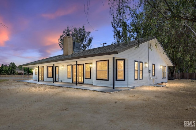 7544 Clifford Ct, Bakersfield, CA 93313 - back of property featuring a chimney and covered porch