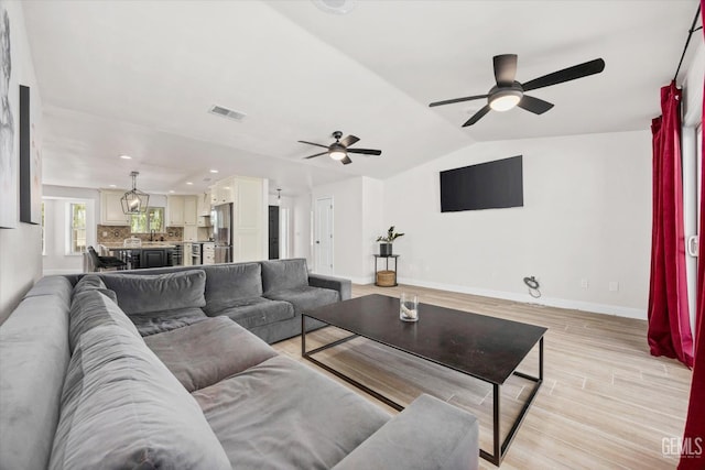 7544 Clifford Ct, Bakersfield, CA 93313 - living area featuring ceiling fan, light wood-style floors, baseboards, vaulted ceiling, and recessed lighting