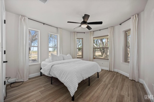7544 Clifford Ct, Bakersfield, CA 93313 - bedroom with multiple windows, light wood-style floors, and baseboards
