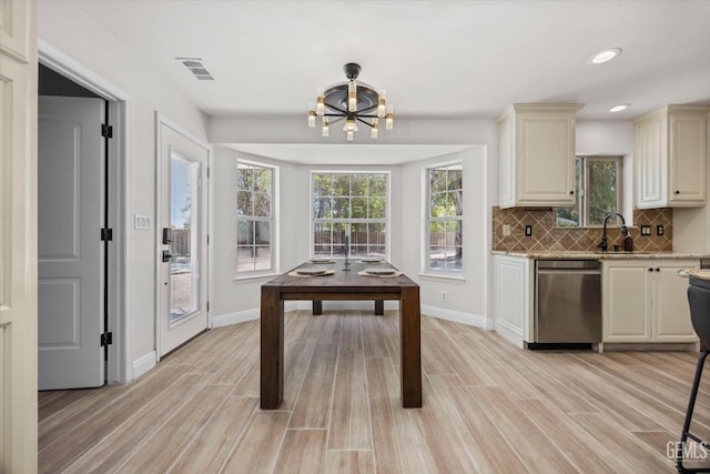 7544 Clifford Ct, Bakersfield, CA 93313 - kitchen featuring dishwasher, light wood-type flooring, decorative backsplash, cream cabinetry, and recessed lighting