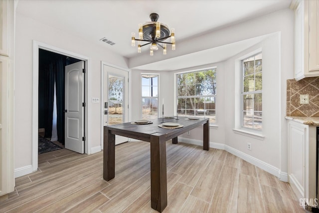 7544 Clifford Ct, Bakersfield, CA 93313 - dining room with a chandelier, light wood-style floors, and baseboards