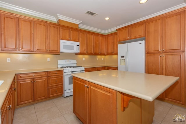 6107 Saint John Pl, Bakersfield, CA 93306 - kitchen with white appliances, light tile patterned flooring, brown cabinets, recessed lighting, and crown molding