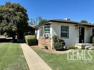 3100 18th St, Bakersfield, CA 93301 - view of property exterior with stucco siding and a lawn