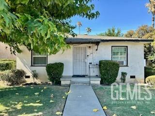 3100 18th St, Bakersfield, CA 93301 - view of front of house featuring a front yard and stucco siding
