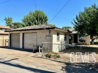 3100 18th St, Bakersfield, CA 93301 - exterior space with fence, a garage, and stucco siding