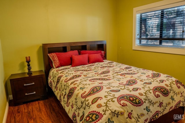 bedroom with dark hardwood / wood-style flooring