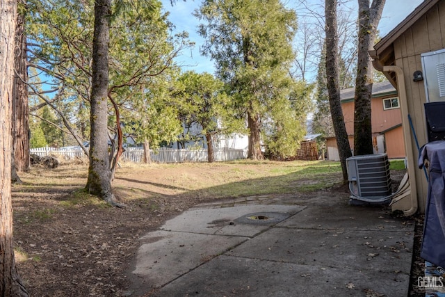 view of yard with central AC unit and a patio area