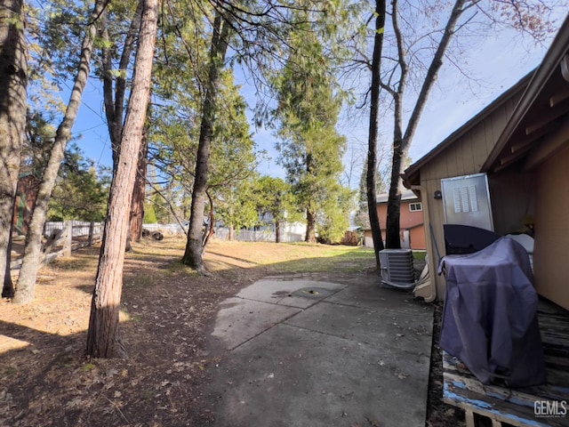 view of yard featuring central air condition unit and a patio area