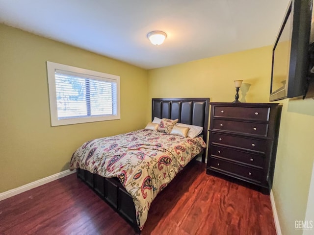 bedroom with dark wood-type flooring