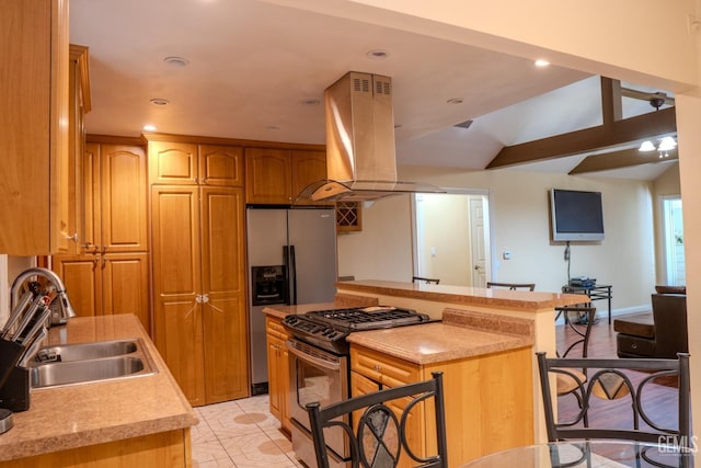 kitchen with sink, stainless steel fridge with ice dispenser, island exhaust hood, black range with gas cooktop, and a kitchen bar