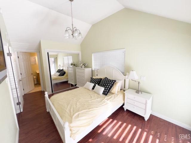 bedroom featuring dark wood-type flooring, vaulted ceiling, a closet, and a notable chandelier