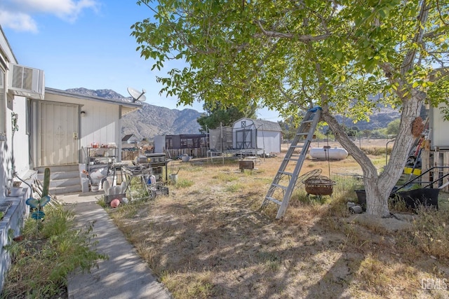 7958 Harmony Ln, Onyx, CA 93255 - view of yard featuring a fire pit, a storage unit, a mountain view, an outdoor structure, and fence