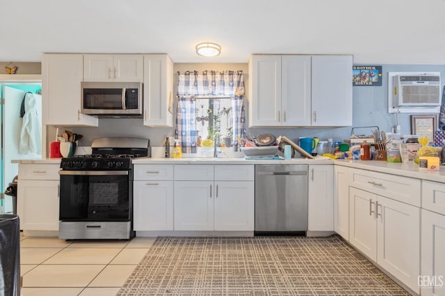 7958 Harmony Ln, Onyx, CA 93255 - kitchen featuring stainless steel appliances, a sink, a wall unit AC, white cabinets, and light countertops