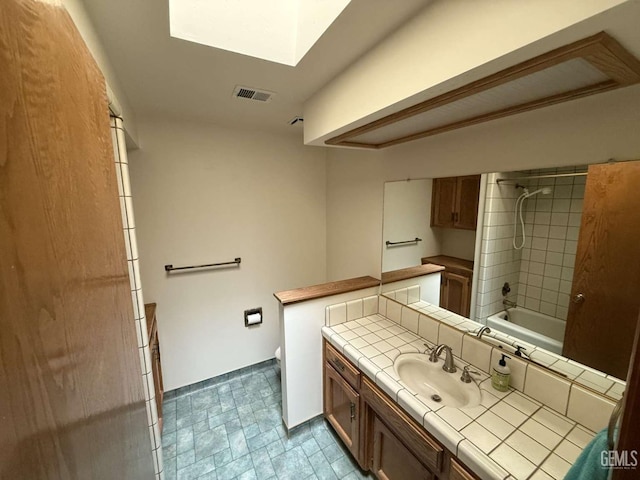 full bath featuring visible vents, vanity, toilet, shower / tub combination, and a skylight