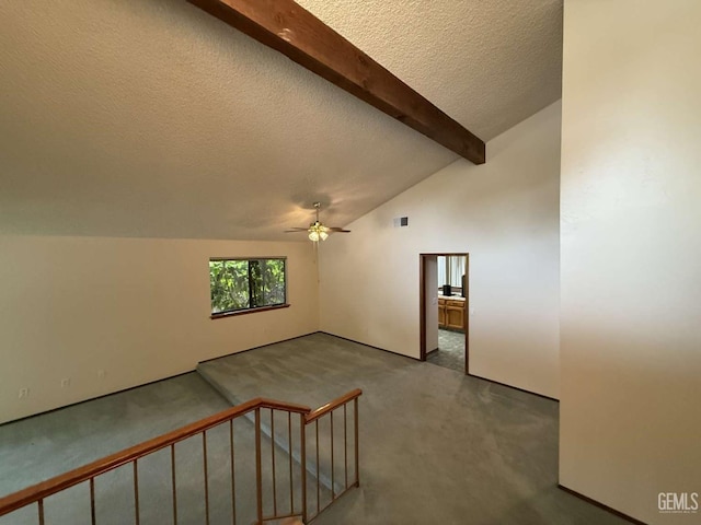 bonus room featuring carpet flooring, a textured ceiling, lofted ceiling with beams, and ceiling fan