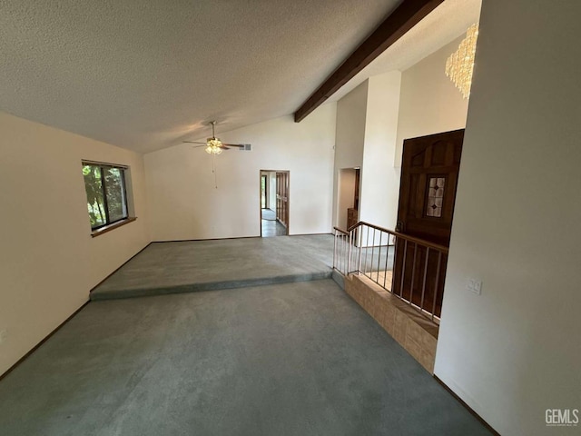 spare room with lofted ceiling with beams, a textured ceiling, ceiling fan, and carpet flooring