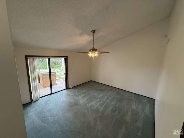 carpeted spare room with a ceiling fan and a textured ceiling
