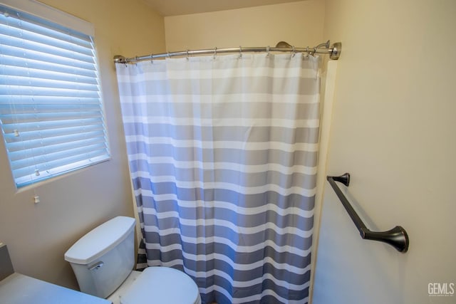 5514 Lombardy Ct, Bakersfield, CA 93308 - full bathroom featuring toilet, plenty of natural light, and a shower with shower curtain