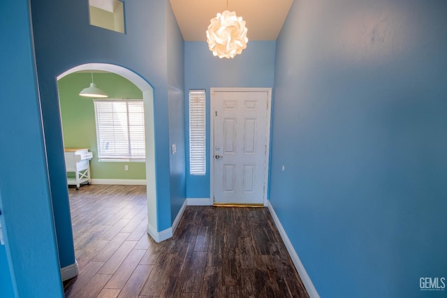 5514 Lombardy Ct, Bakersfield, CA 93308 - entryway featuring dark wood-style floors, a chandelier, baseboards, and arched walkways