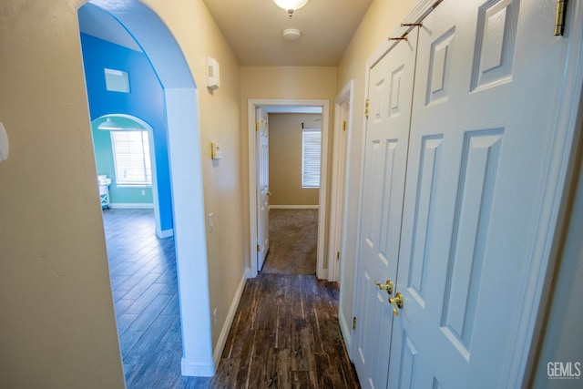 5514 Lombardy Ct, Bakersfield, CA 93308 - hallway with dark wood finished floors, baseboards, and arched walkways