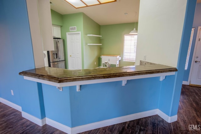 5514 Lombardy Ct, Bakersfield, CA 93308 - kitchen with stainless steel fridge, dark wood-style flooring, baseboards, and white cabinets