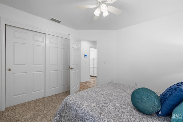 unfurnished bedroom with visible vents, a ceiling fan, carpet floors, and a closet
