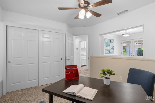 home office with visible vents and ceiling fan