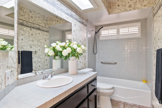 bathroom with washtub / shower combination, wallpapered walls, vanity, and toilet