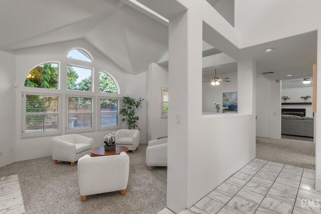 living room with a brick fireplace, high vaulted ceiling, marble finish floor, a ceiling fan, and recessed lighting