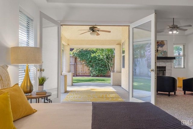 interior space featuring carpet floors, ceiling fan, and a fireplace