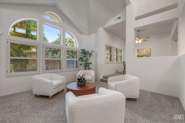 interior space with carpet floors, ceiling fan, visible vents, and high vaulted ceiling