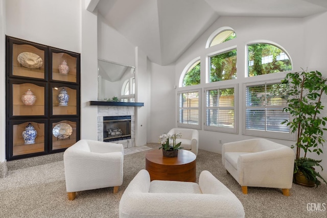 carpeted living room featuring a fireplace and lofted ceiling