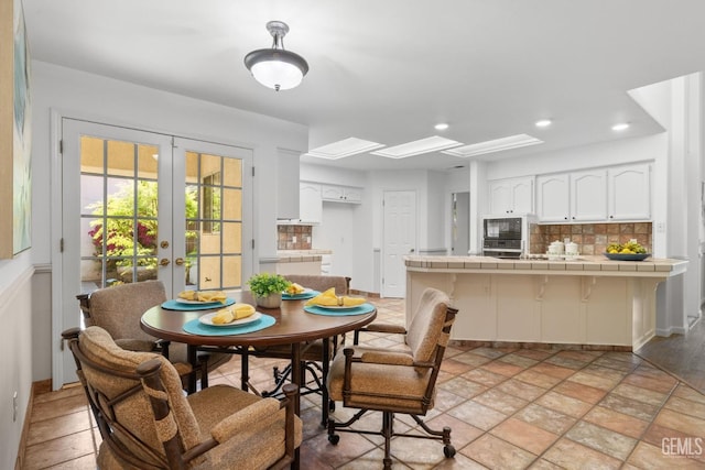 dining room featuring baseboards, french doors, and recessed lighting